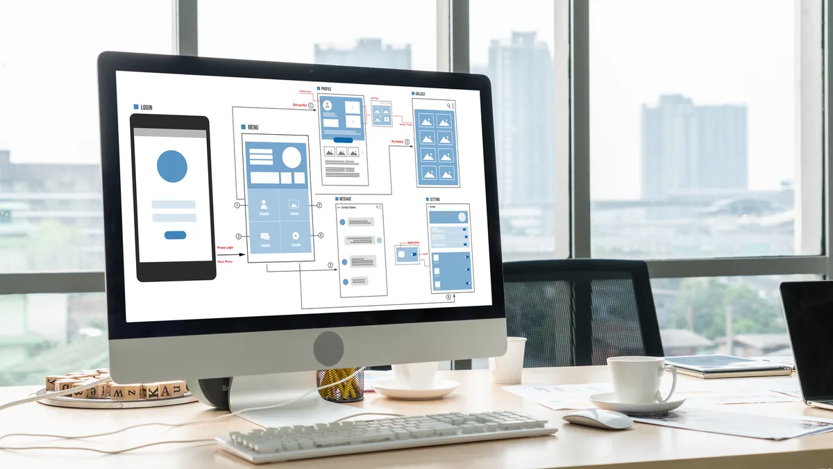 Mobile app wireframes and interface designs displayed on a desktop monitor.